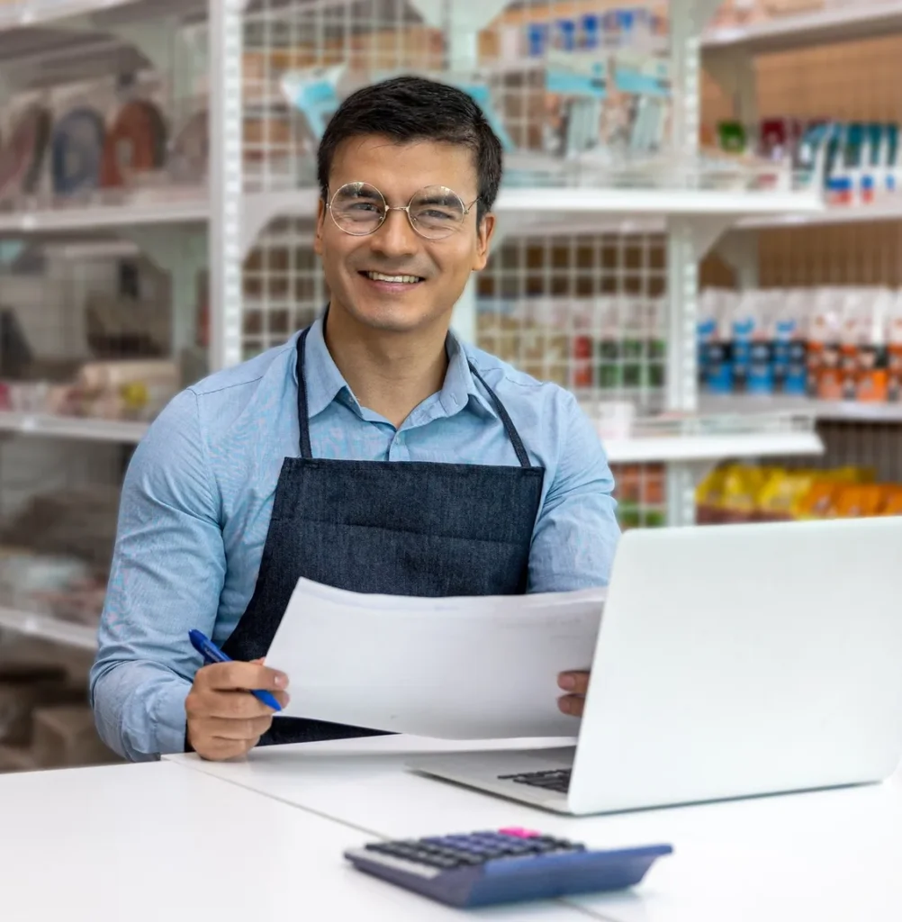 Store owner working at a laptop