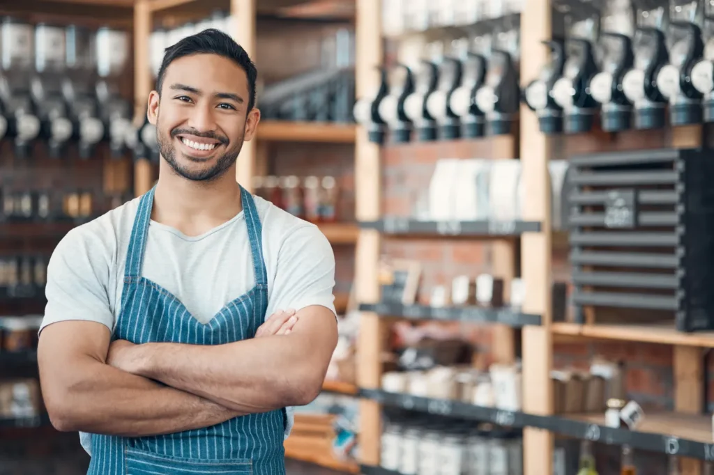 Smiling shop owner with arms crossed
